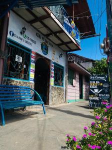 a building with a blue bench in front of it at Hotel My Isla Bonita in Moyogalpa