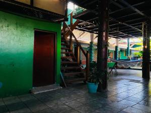 a green wall with a staircase in a building at Hotel My Isla Bonita in Moyogalpa
