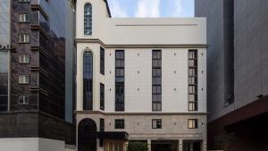 a white building with tall buildings at Aank Resort & Spa Busan Haeundae in Busan