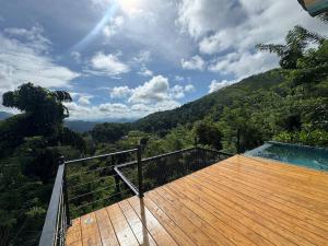 a wooden deck with a view of a mountain at Glenmour Resort Ella in Ella