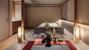 a living room with a tub and a table with flowers at Aank Resort & Spa Busan Haeundae in Busan