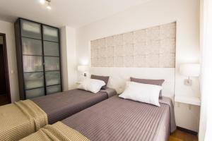 En eller flere senge i et værelse på Spacious Apartment in Lisbon