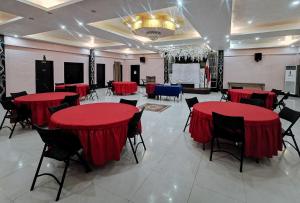a banquet hall with red tables and chairs at Sunrise Garden Lake Resort in Lahit