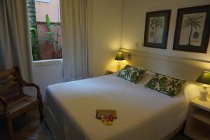 Cama ou camas em um quarto em Pousada Terra Juquehy
