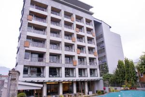 an apartment building with a pool in front of it at Soaltee Westend Lakeside Pokhara in Pokhara