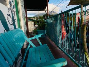 a blue bench sitting on a balcony next to a fence at Hotel My Isla Bonita in Moyogalpa +1 photo