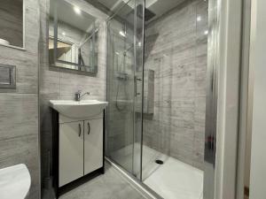 a bathroom with a shower and a sink and a toilet at SAS Militaria dla 2 par 2 pokoje 4 osobysamodzielne zameldowanie, kody w wiadomości przed przyjazdem in Borne Sulinowo +22 photos
