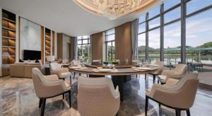 a living room with a dining table and chairs at Dongguan Yingbin Hotel in Dongguan