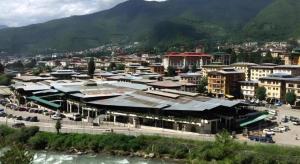 a city with a large building and a river at Hotel Valley Thimphu in Tshalunang