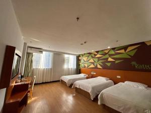 a hotel room with two beds and a television at Vatica JiangsuJianguo Road Xuanwu Market Hotel in Xuzhou +193 photos