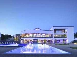 a large building with a pool in front of it at Sonniges Studio im Haus Deutsch Krone in Bad Rothenfelde