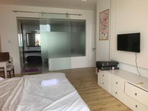 a bedroom with a bed and a flat screen tv at Ocean Vista Resort Sealink Phan Thiet in Ấp Phú Tịnh (2)