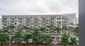 a large building with trees in front of it at Jinjiang Inn Select Xiamen International Airport in Xiamen