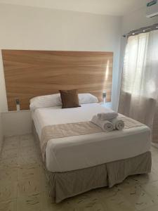 A bed or beds in a room at Casa Palmeras