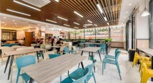 a restaurant with tables and chairs and people in it at Gya Hotel Hangzhou Yuhang District Smart Town Wanda Plaza in Cangqian
