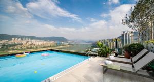 a swimming pool on the roof of a building at FunGee X Hotel Wanzhou Wanda Plaza Branch in Wanzhou