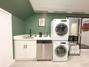 a kitchen with a washing machine and a washer and dryer at Bright & Spacious House Near UBC in Vancouver
