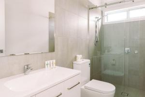 a bathroom with a toilet and a sink and a shower at Eden Bay Mornington in Capel Sound