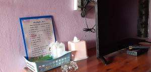 a desk with a mirror and a candle on a table at Saran Resort room 11 in Buriram