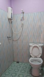 a bathroom with a shower and a toilet in a stall at Saran Resort room 11 in Buriram