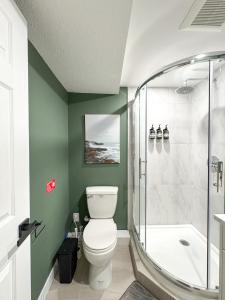 a bathroom with a toilet and a shower at Bright & Spacious House Near UBC in Vancouver