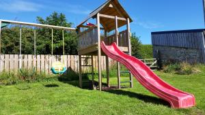 a playground with a slide and a swing at Old Farm Holiday Cottages - Scottish Borders in Chirnside