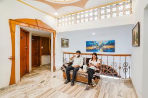 a group of people sitting on a couch in a house at FabHotel Rest & Peace in Ahmedabad