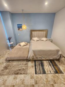 En eller flere senge i et værelse på Suite Blue - Rodadero Sur