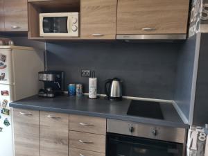 a kitchen with a stove top oven next to a refrigerator at Pleven View in Pleven