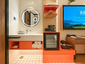 a bathroom with a sink and a mirror at QiuGuo Hotel Chao He Beijing Dashilan Xijie Qianmen Subway Station Branch in Beijing +46 photos