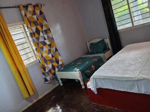 a small bedroom with a bed and a window at Daijan villa in Ukunda +4 photos