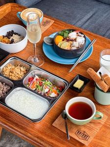 a wooden table topped with a tray of food and drinks at The Xcape River Kwai in Kanchanaburi
