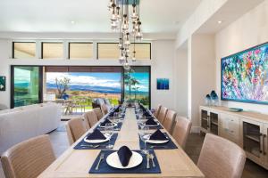 ワイメアにあるBLUE SERENITY Luxurious home in private community with Heated Private Pool Spa Detached Ohana Suiteの長いテーブルと椅子のあるダイニングルーム