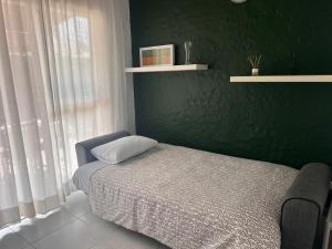 a bedroom with a bed and a green wall at Mar y Sol in Maspalomas +66 photos