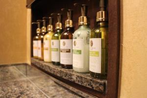 a row of wine bottles sitting on a shelf at HOTEL C-L'esapce in Honjo