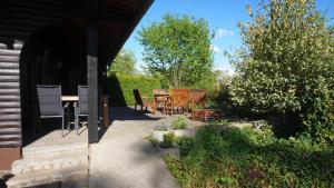 a patio with a table and chairs in a garden at Blockhaus in Anraff