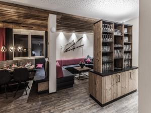 a rendering of a wine tasting room with a couch and tables at Chalet Montafon in Gaschurn with Sauna in Gaschurn