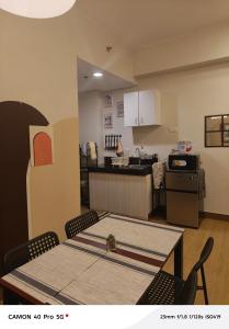 a kitchen and dining room with a table and chairs at K&C Suite in Trece Martires +17 photos