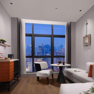 a living room with a view of a city at Yuezhi Hotel Longnan Yingbin Avenue Branch in Magutang +10 photos