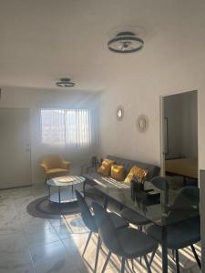 a living room with a couch and a table and chairs at Departamento Premium en Acapulco in La Sabana