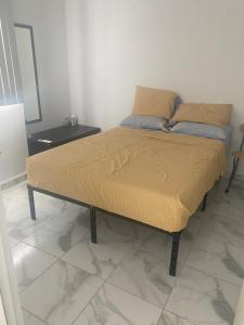 a bed sitting in a room with at Departamento Premium en Acapulco in La Sabana +9 photos