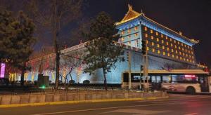 a building with a bus parked in front of it at Jinjiang Inn Xi'an Zhonglou North Street Metro Station in Xi'an