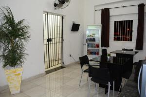 a dining room with a table and black chairs at Lize Hotel in Campinas +37 photos