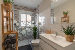 a bathroom with a sink and a toilet and a shower at Satu Granada Modern Apartment in the Albaicín in Granada