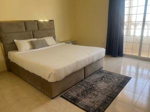 a bedroom with a large bed with a large headboard at doge villa 3 in Dubai