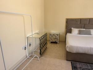 a bedroom with a bed and a side table at doge villa 3 in Dubai +4 photos