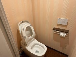 a bathroom with a toilet with the seat up at Aparthotel STATUS SUSUKINO 102 in Sapporo +6 photos