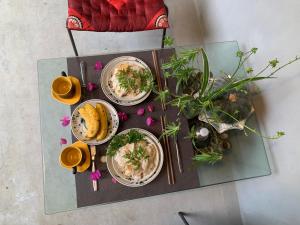 a table with three plates of food on it at Tam Coc Eco House in Ninh Binh