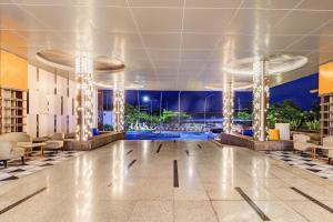 a lobby with a dance floor with lights at Sunday Hotel Arshika Sunset Road in Kuta +133 photos