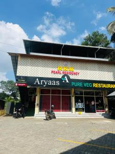 a store with two motorcycles parked in front of it at RKM Pearl in Cochin